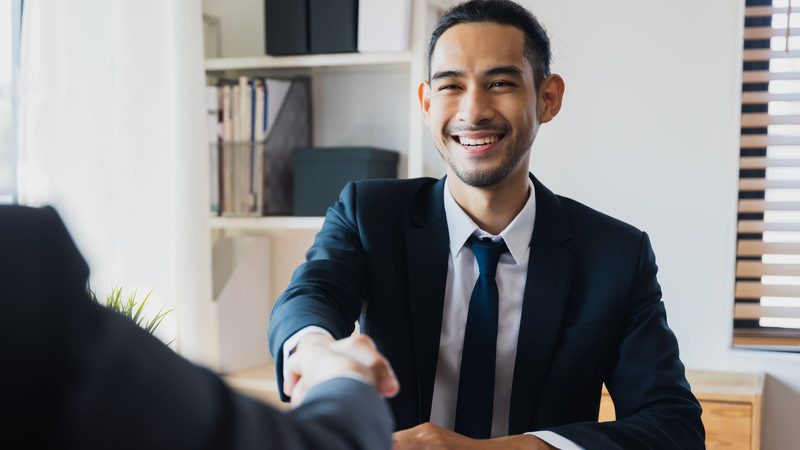 Cheerful bank relationship manager greeting a customer