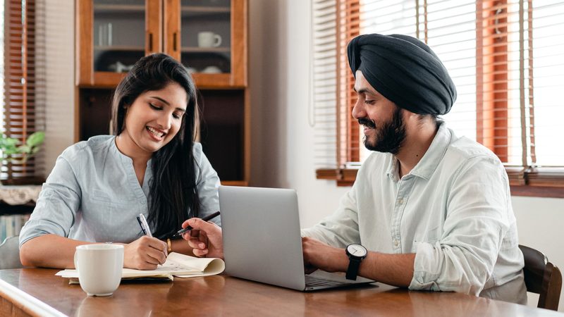 Young software engineers smiling at their desks