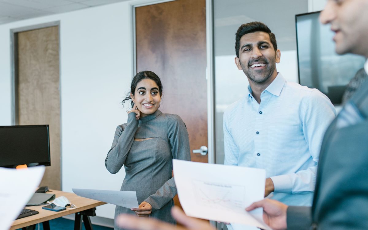 Happy recruitment team discussing candidates in a meeting room